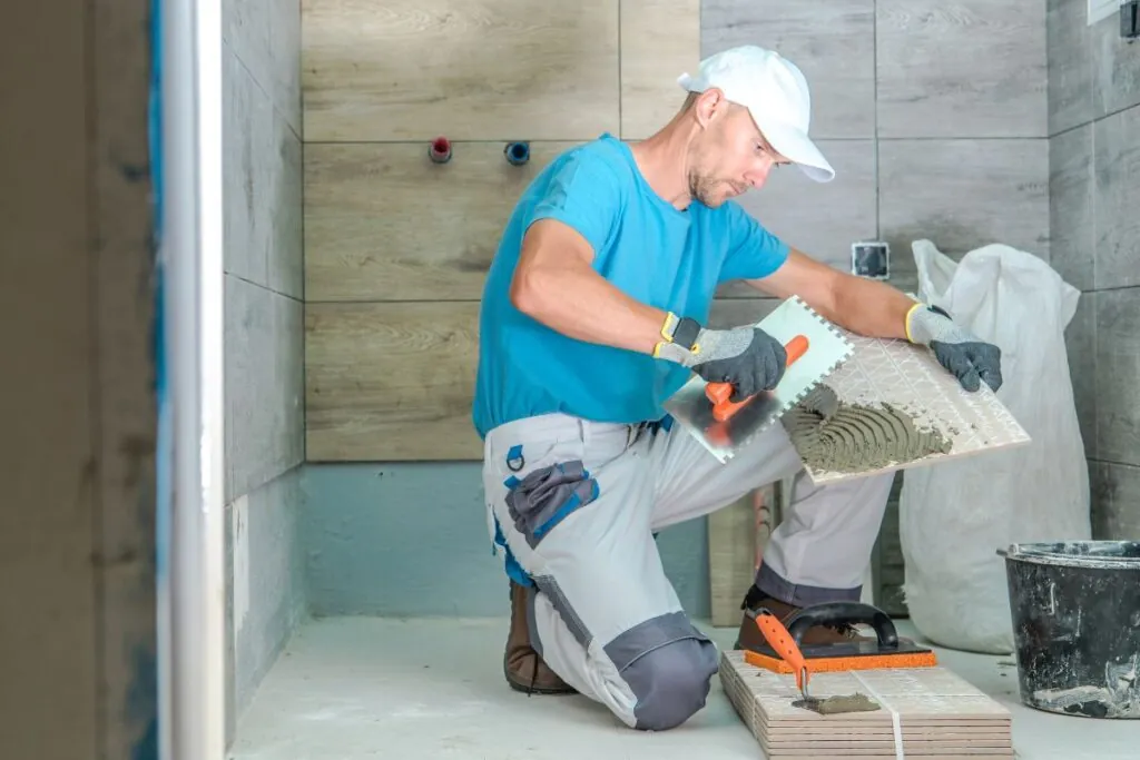 tile installer remodeling the bathroom