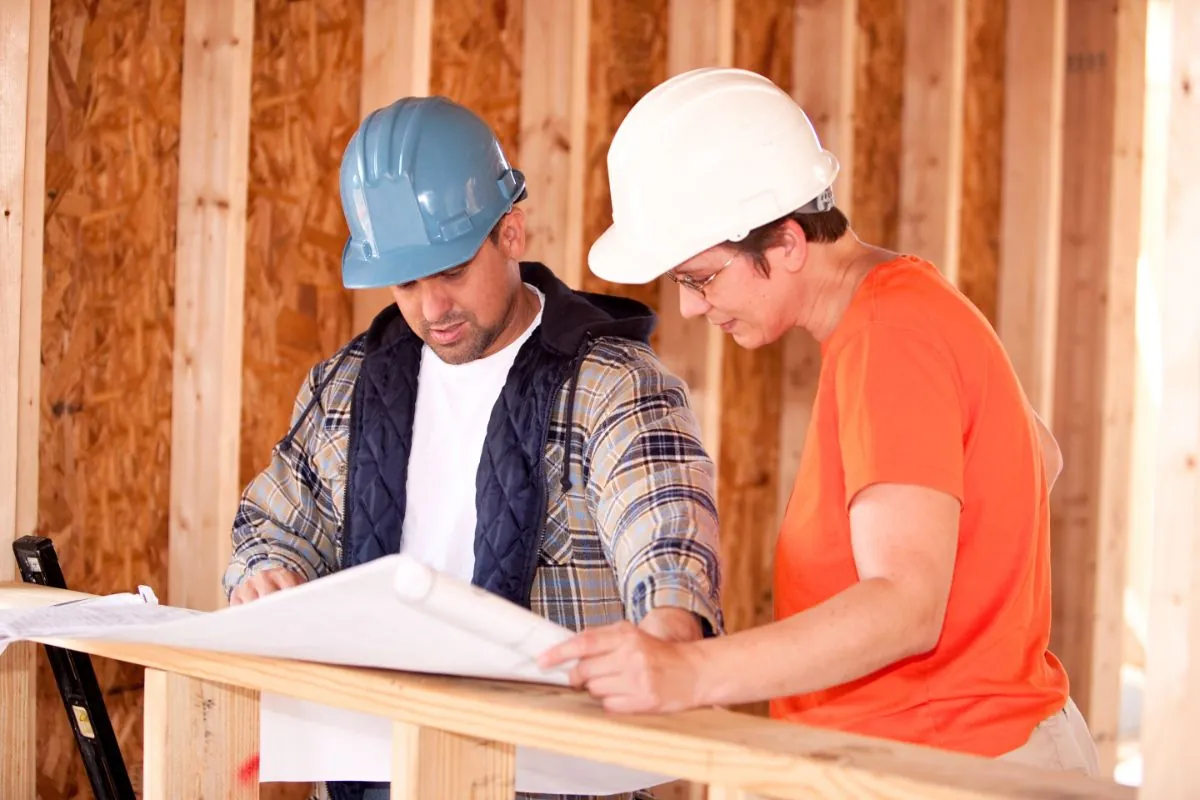 contractors showing home renovation plan to client