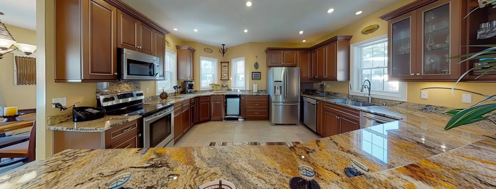 a modern kitchen with granite countertops and stainless steel appliances in randolph ma